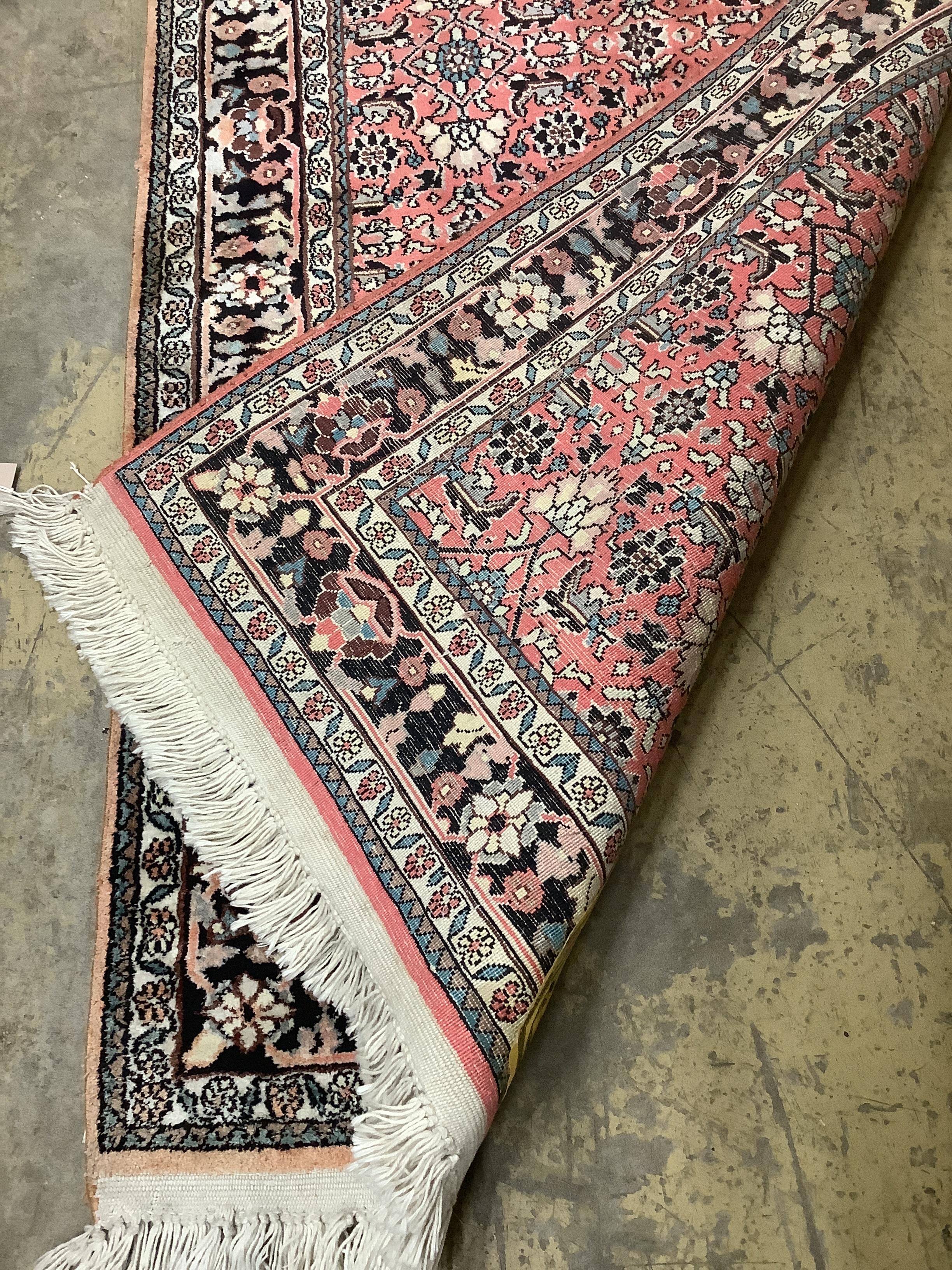A North West Persian peach ground rug,120 x 76cm